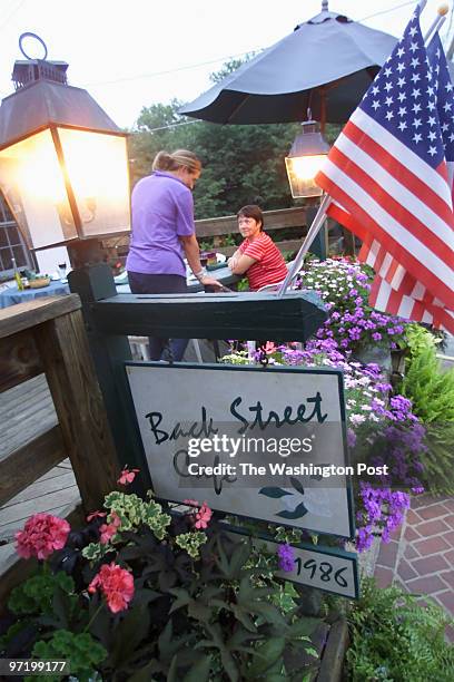 Woodwardt 131105 Review of the Backstreet Cafe in Middleburg, VA. Customers Liz Millikin and Lee Ann Manuel , take their seats on the patio of the...