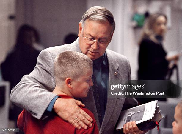 The Rev. Clyde Duncan of the First Baptist Church, Kingstowne, greets 9-year-old David Cox just before the start of services that are being held in a...