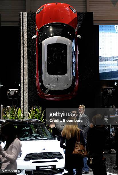 Employees set up the Mini stand prior to the official opening of the Geneva International Motor Show in Geneva, Switzerland, on Monday, March 1,...
