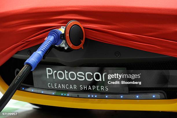 Protoscar electric automobile is charged prior to the official opening of the Geneva International Motor Show in Geneva, Switzerland, on Monday,...