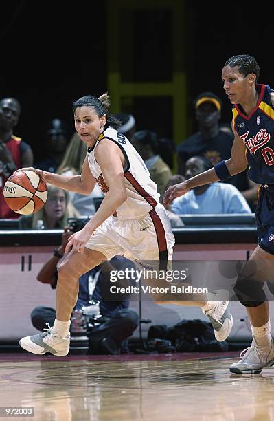 Sandy Brondello of the Miami Sol drives past Olympia Scott-Richardson of the Indiana Fever during the game on June 30, 2002 at American Airlines...