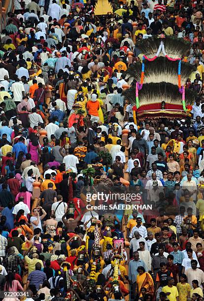 Hindu devotees climb 272 steps up to the temple at the Batu cave at sun rise during the Thaipusam festival at the Batu cave in Kuala Lumpur on...