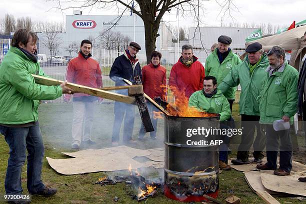 Trade union members gather around a fire at the Kraft Foods site in Halle, On March 1, 2010. Trade unionists blocked the entrance to the site early...