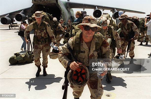 Over 1,000 US Marines from Fort Bragg disembark from a Lockheed C-5 Galaxy transport plane at Dhahran air base in Saudi Arabia, 21st August 1990....