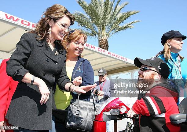 Former Alaska Governor Sarah Palin talks with actor Fred Gill aka at the Daytona International Speedway on February 14, 2010 in Daytona Beach,...