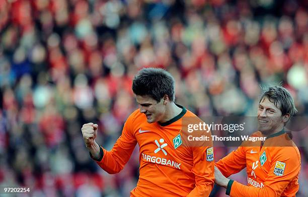 Sebastian Proedl of Bremen celebrates after scoring the 2:1 with his team mate Aaron Hunt during the Bundesliga match between FSV Mainz 05 and SV...