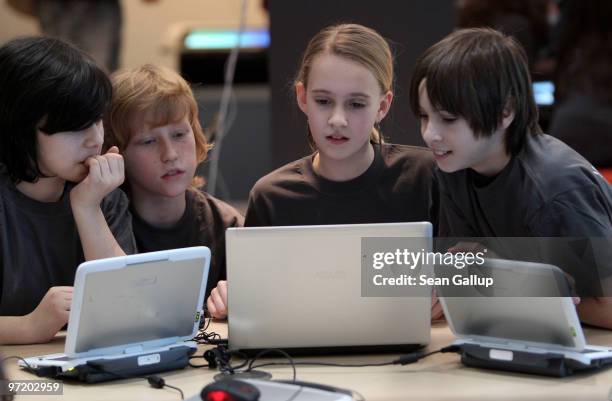 Children try out networked computer laptops in the Digitial Classroom at the Microsoft stand at the CeBIT Technology Fair on March 1, 2010 in...