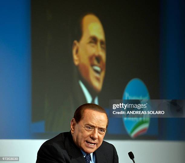 Italian Prime Minister Silvio Berlusconi speaks during a meeting as he promotes a candidate for the next regional elections at Temple of Hadrian in...