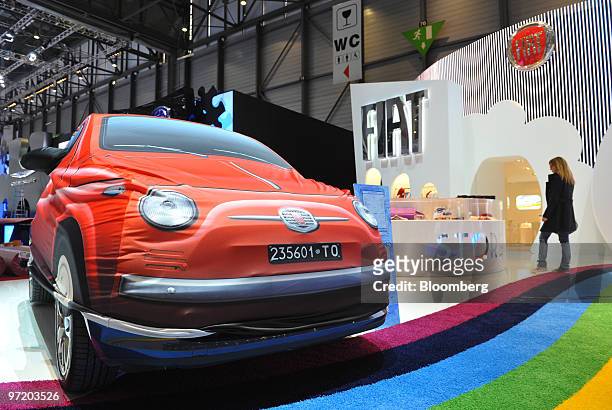 Fiat SpA 500 automobile is seen covered prior to the official opening of the Geneva International Motor Show in Geneva, Switzerland, on Monday, March...