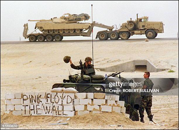 Army Military Police sit at their check point along a convoy route 20 January 1991 somewhere in Saudi desert. The MP's said they wrote the name of...