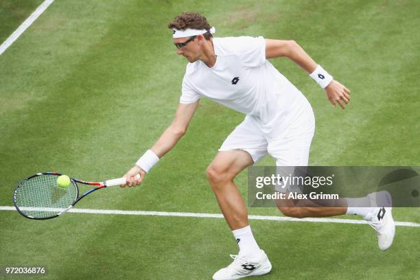 Denis Istomin of Uzbekistan plays a forehand to Philipp Kohlschreiber of Germany during day 2 of the Mercedes Cup at Tennisclub Weissenhof on June...