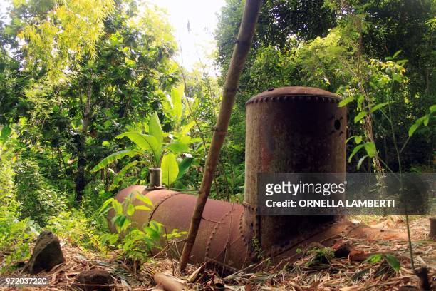 Picture taken on June 11, 2018 near M'Tsangamouji on the French territory of Mayotte, shows an old machinery at Soulou former sugar factory, one of...