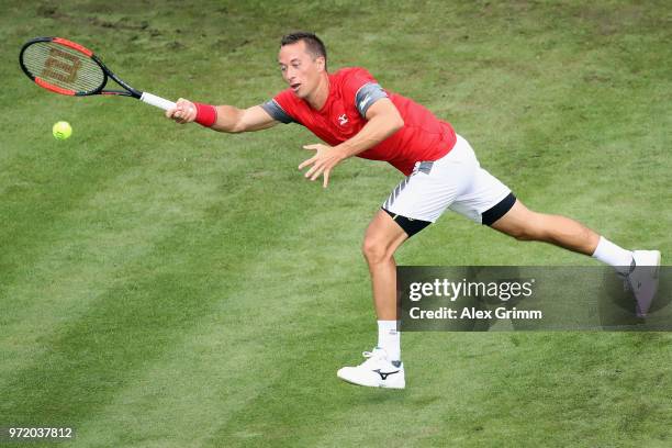 Philipp Kohlschreiber of Germany plays a forehand to Denis Istomin of Uzbekistan during day 2 of the Mercedes Cup at Tennisclub Weissenhof on June...