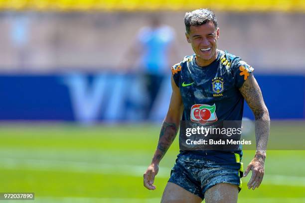 Philippe Coutinho of Brazil reacts after having eggs smashed on his head as a birthday prank during a Brazil training session ahead of the FIFA World...