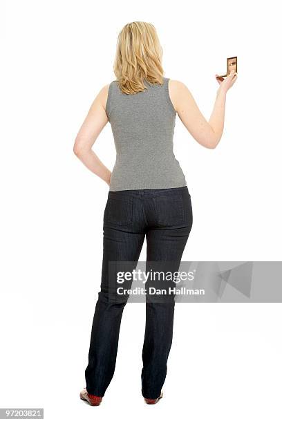 woman looking into compact mirror - woman-looking-into-mirror-full-body stock pictures, royalty-free photos & images