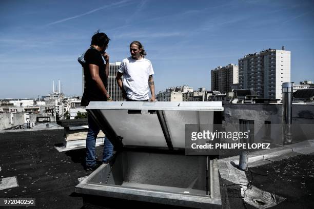 Johan Tonnoir speaks with a friend as he practices Parkour, an obstacle course method derived from military training "parcours du combattant" , on...