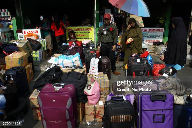 Homecomers are waiting for the bus that will take them back to their hometown, during the annual mass exodus season to welcoming Eid al Fitr, in...