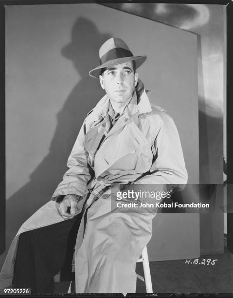 American actor Humphrey Bogart in trench coat and trilby, 1940.