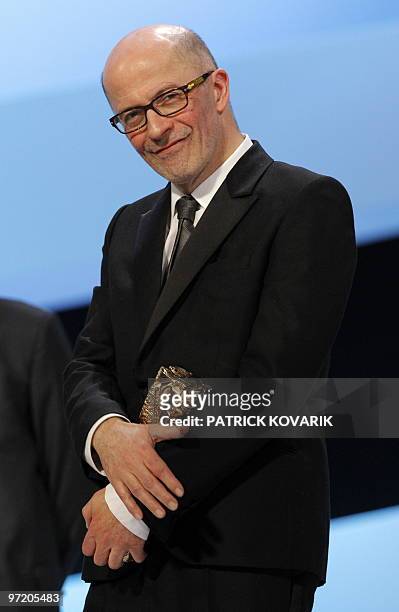 French director Jacques Audiard poses with his third award for his movie "Un prophete" during the 35th Cesars French film awards ceremony on February...