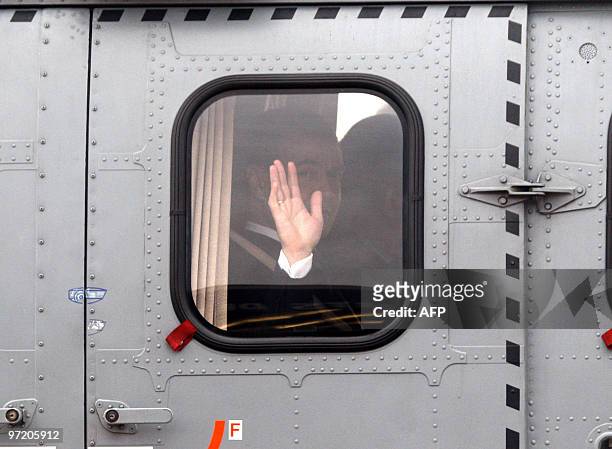 Russian President Dmitry Medvedev waves through the window of the helicopter upon his arrival at Paris Orly airport, on March 1, 2010. Medvedev is...