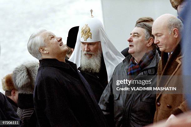 Russian president Boris Yeltsin looks up to the top of the Christ the Saviour Cathedral as Patriarch of Moscow and All Russia Alexy II stands next to...