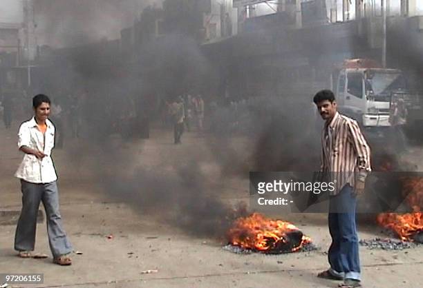 Yemeni protestors stand next to burning tyres in the town of Zinjibar in southern Yemen during clashes which broke out on March 01, 2010 after...