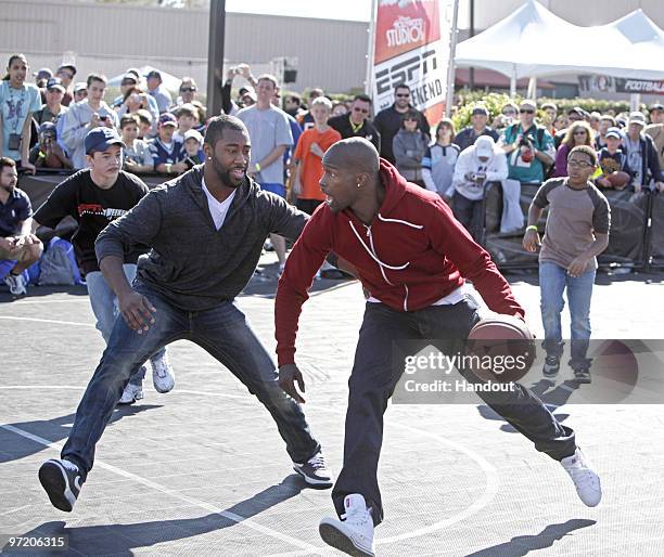 In this handout photo provided by Disney, Cincinnati Bengals wide receiver Chad Ochocinco drives to the basket as New York Jets cornerback Darrelle...