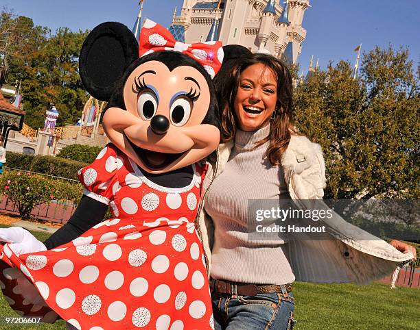In this handout photo provided by Disney, Actress Eva La Rue, star of the CBS series "CSI: Miami," poses with Minnie Mouse at the Magic Kingdom on...