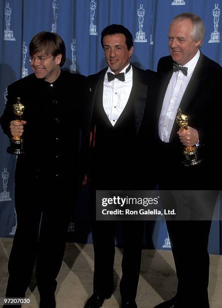 Musician Elton John, actor Sylvester Stallone and lyricist Tim Rice attend the 67th Annual Academy Awards on March 27, 1995 at Shrine Auditorium in...