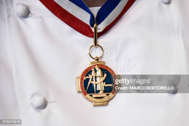 The medal of Paul Bocuse's academy is pictured on the chest of a French chef during the event of the Bocuse d'Or Europe 2018 International culinary...