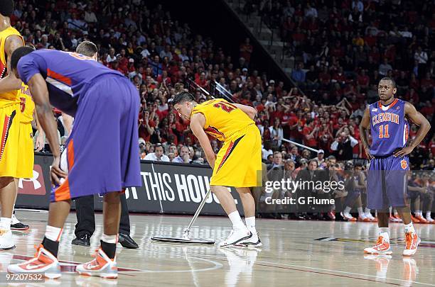 Greivis Vasquez of the Maryland Terrapins mops up the floor during a time out in the game against the Clemson Tigers at the Comcast Center on...