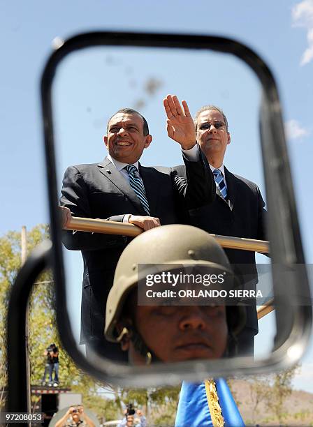 Honduran President Perfirio Lobo and Minister of Defense Marlon Pascua are driven from the inauguration ceremony of newly instated head of the...