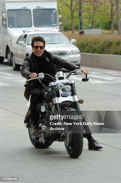 Actor Tom Cruise rides a motorcycle to the Tribeca Performing Arts Center during a whirlwind tour of New York City to promote his new movie,...