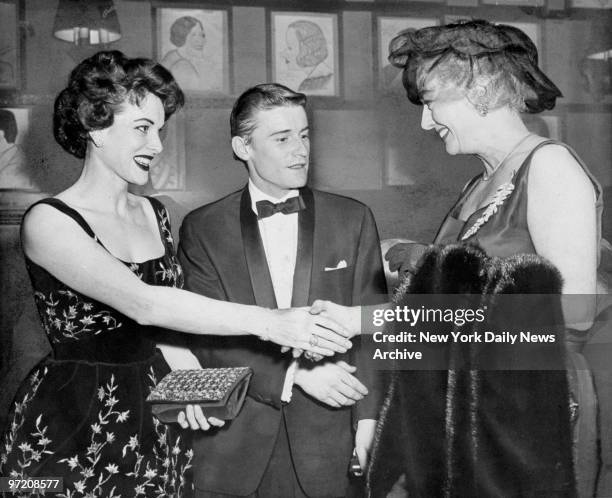 Actress Maureen O'Hara greets Joan Crawford as Roddy McDowall looks on at Sardi's, where they arrived for the annual New York Film Critics Awards...