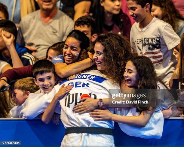 Anna Maria Wagner of Germany is movingly congratulated by her fans as she leaves mat after winning the u78kg bronze medal during day three of the...