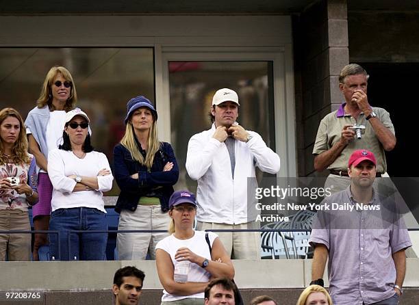 Actor Kevin Spacey adjusts his collar as he and actress Helen Hunt take in the men's final in the U.S. Open at Flushing Meadows.