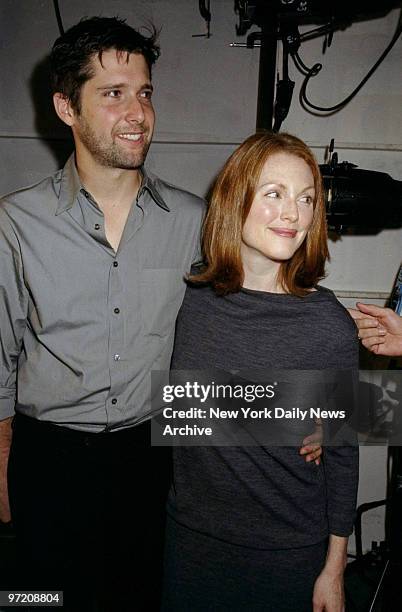 Actress Julieanne Moore and her husband director Bart Freundlich are on hand backstage at designer Mark Eisen's spring/summer 1999 fashion show at...