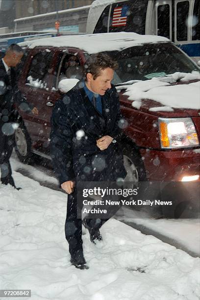 Actor Michael J. Fox makes his way through the snow as he leaves the People Magazine "Heroes Among Us" awards luncheon at the New York Public Library.