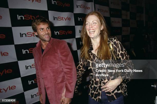 Actress Julianne Moore arrives with a friend for an InStyle magazine party to promote makeup artist Kevyn Aucoin's book, "Face Forward," at the Lotus...