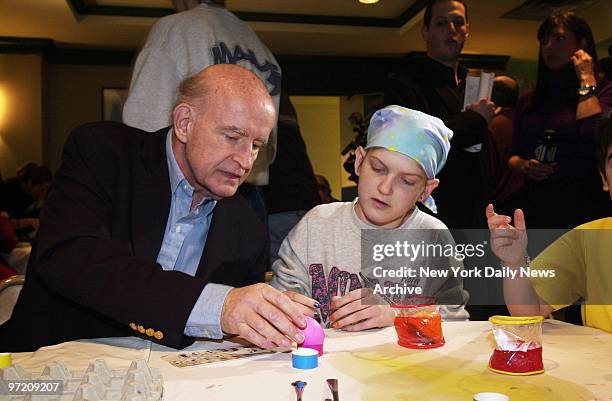 Actor Peter Boyle helps Jessica Nielsen color Easter eggs at the Ronald McDonald House on E. 73rd St.