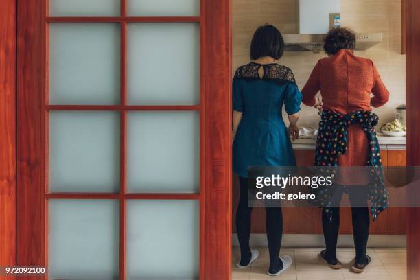 chinese mother and daugher together in kitchen - asian mom cooking stock pictures, royalty-free photos & images