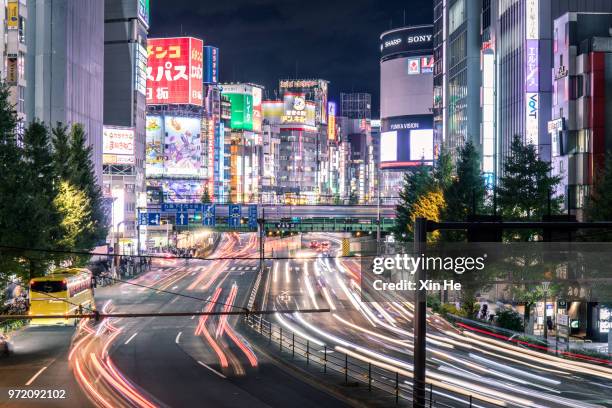 busy commuters in shinjuku at night and the view of tokyo street / tokyo, japan - xin he stock pictures, royalty-free photos & images