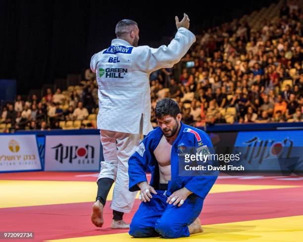 Toma Nikiforov of Belgium celebrates after strangling Cyrille Maret of France into submission to score an ippon and win the u100kg gold medal during...