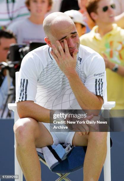 An emotional Andre Agassi is seated after his loss to Benjamin Becker during his third-round match in the 2006 U.S. Open at Arthur Ashe Stadium in...