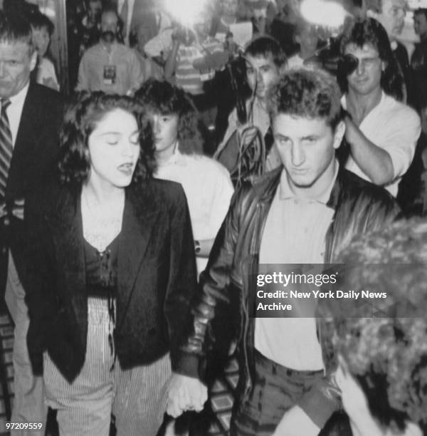 Actor Sean Penn and Madonna are forced out by crush of press during party at Imperial Ballroom.