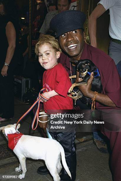 Actors Josh Ryan Evans and Ben Vereen show off some of the pooches up for adoption during the Broadway Barks 3! benefit at Shubert Alley. The annual...