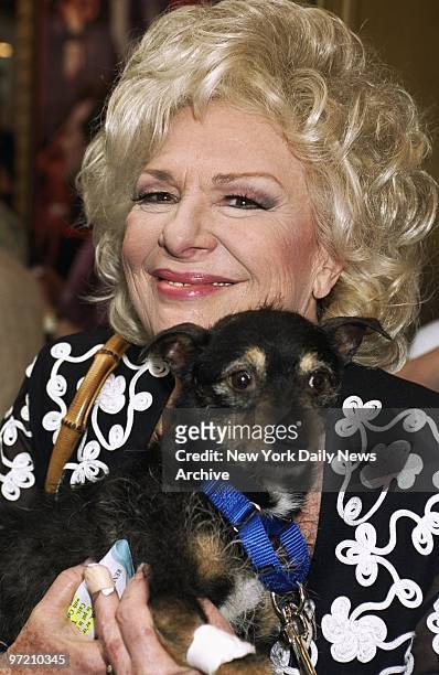 Actress Renee Taylor cuddles a pooch which is up for adoption during the Broadway Barks 3! benefit at Shubert Alley. The annual event encourages the...