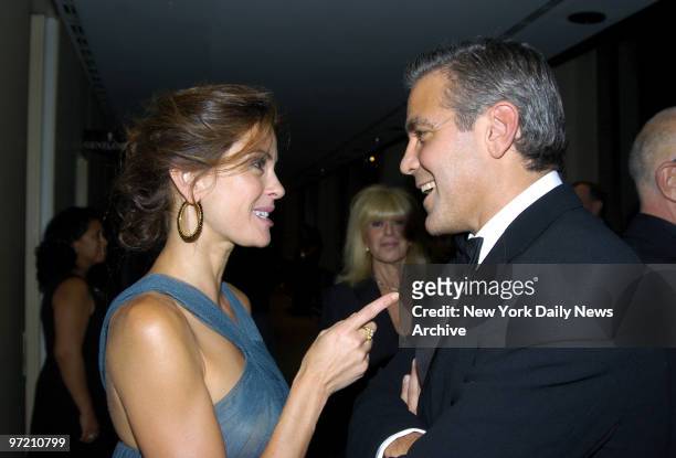 Actress Teri Hatcher of "Desperate Housewives" has an animated conversation with actor George Clooney at Lincoln Center's Avery Fisher Hall before...