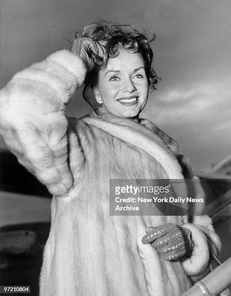 Actress Debbie Reynolds boards a TWA plane at Idlewild Airport for trip to Madrid.