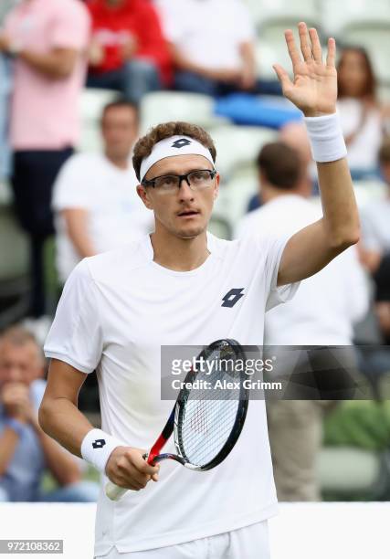 Denis Istomin of Uzbekistan celebrates after winning his match against Philipp Kohlschreiber of Germany during day 2 of the Mercedes Cup at...
